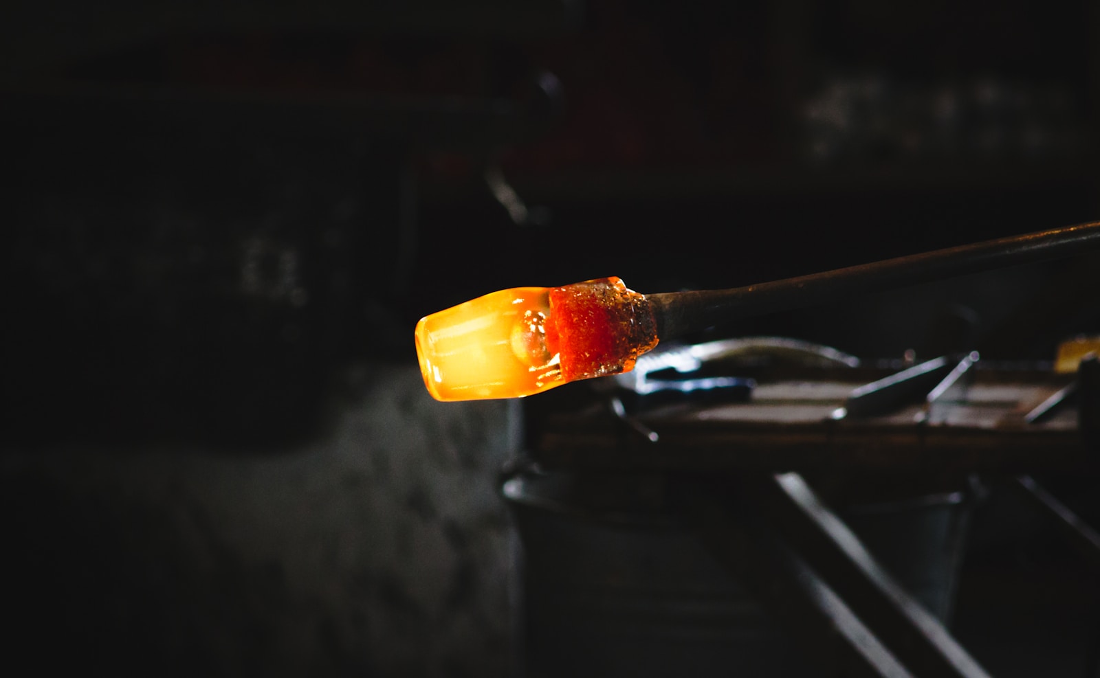 A glassmaker at the bench, hot glass on the rod